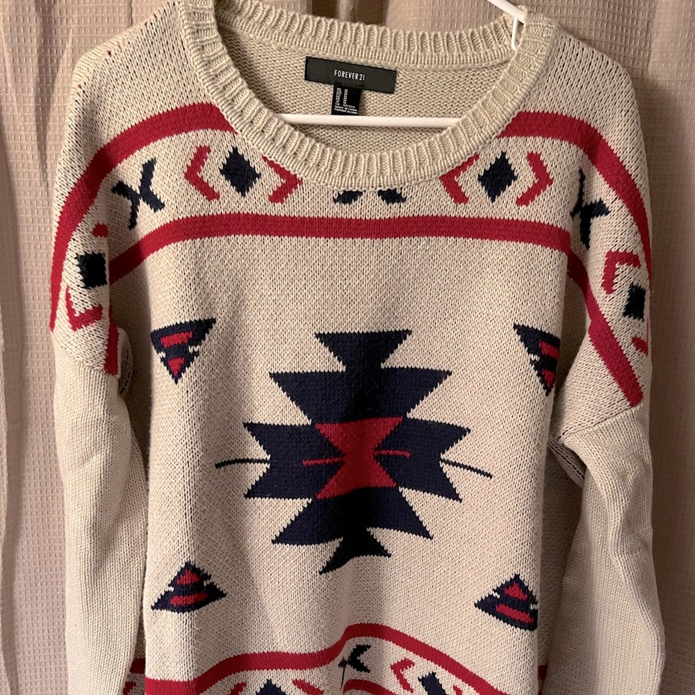 Crocheted beige sweater with navy blue and red detail. Size: Medium. LIKE NEW